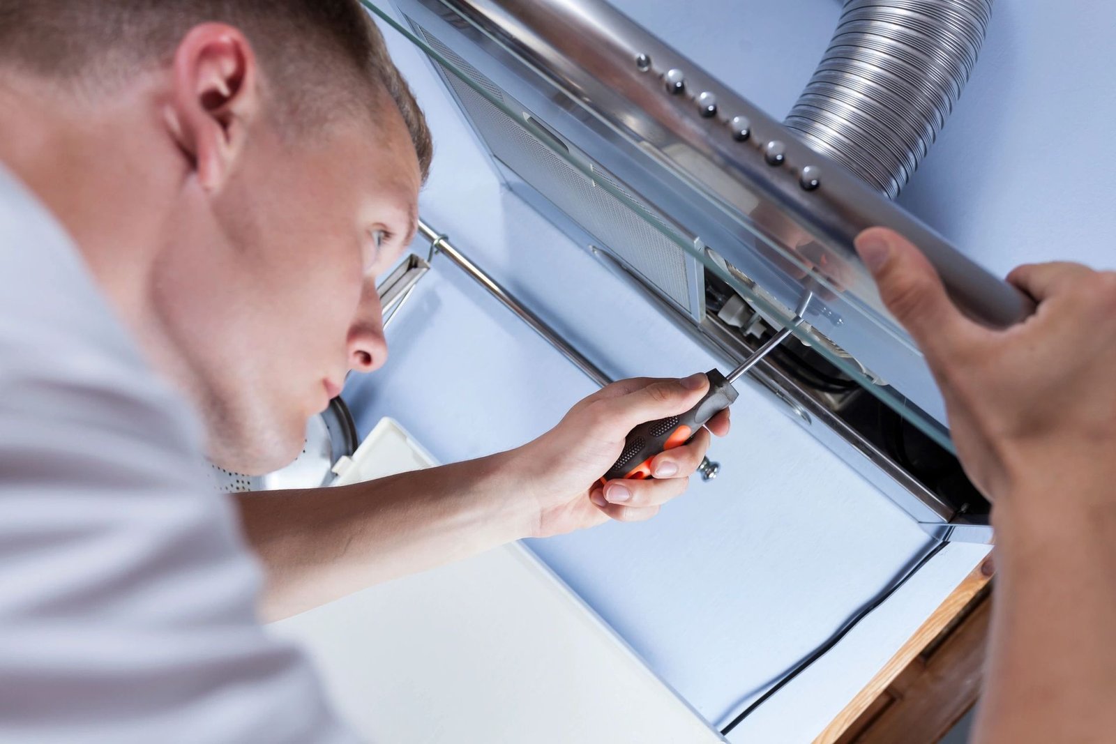 Appliance repair technician servicing a home appliance
